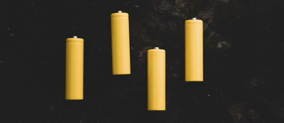 four batteries lying on a flat surface